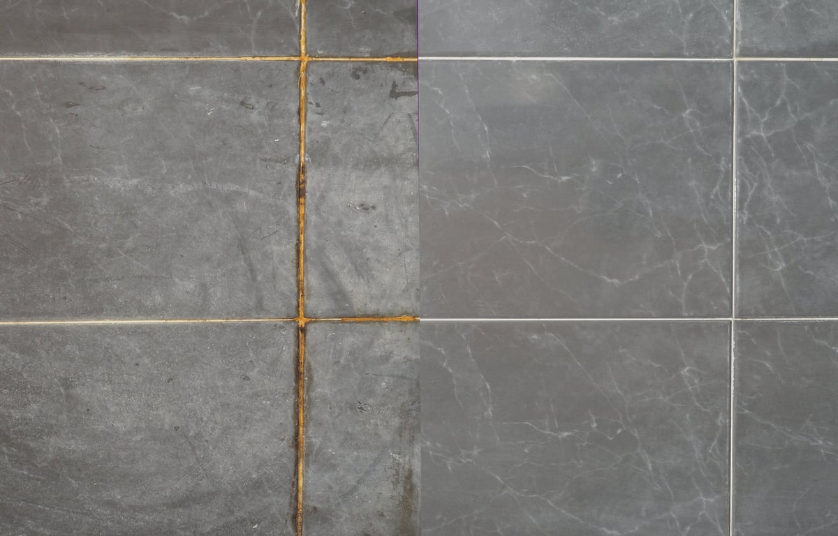 Restored grout between marble tiles in a bathroom after professional cleaning