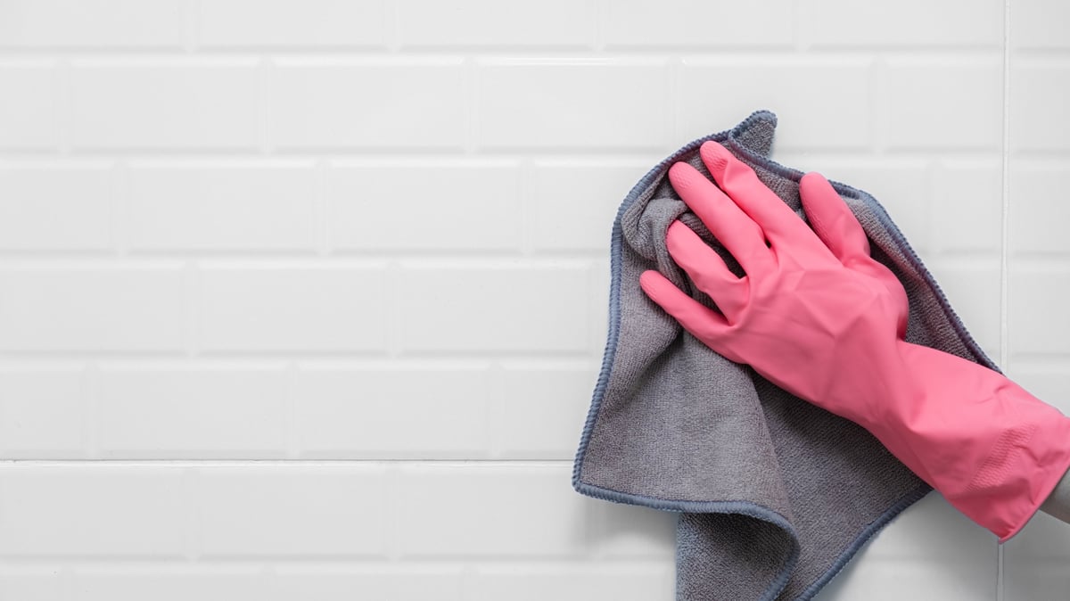 Cleaning white subway tiles in a bathroom